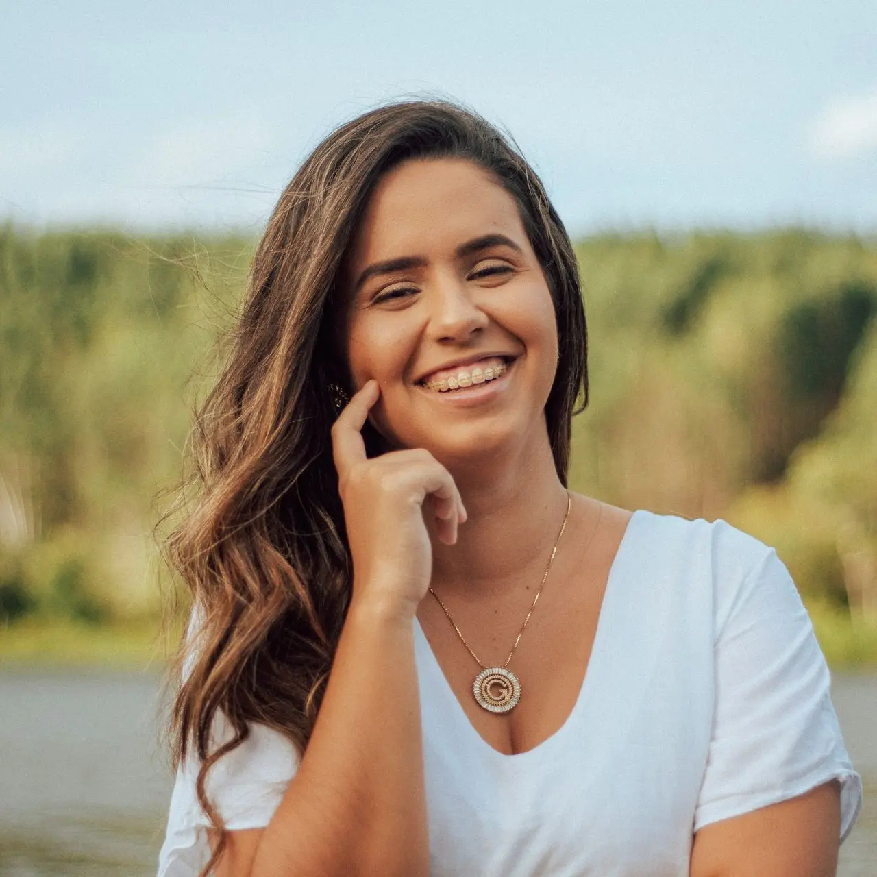 woman in white scoop neck shirt smiling