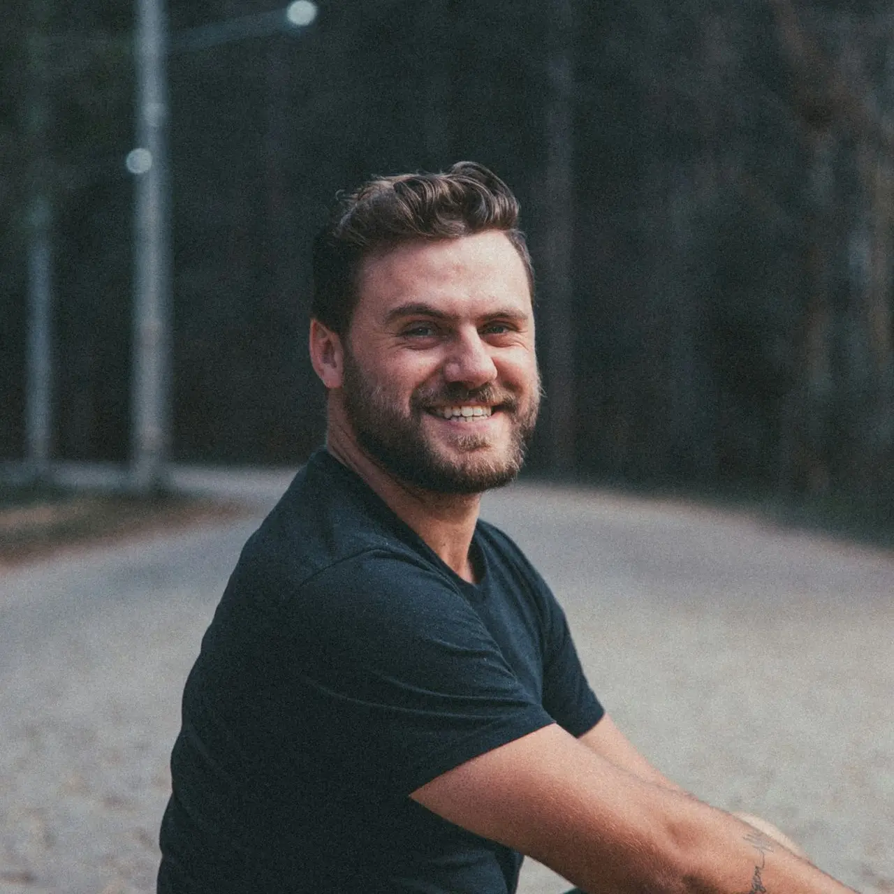 man sits on road